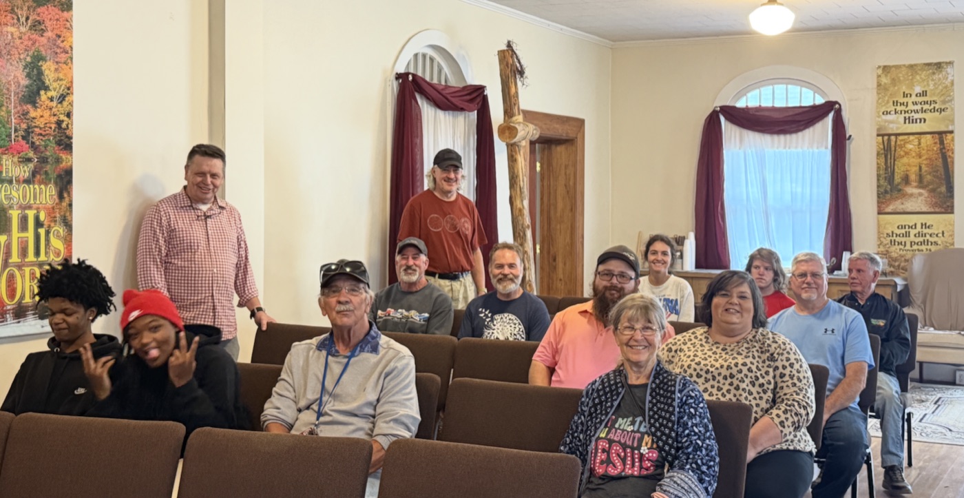 Members of Good News Community Church seated together in the sanctuary, smiling toward the camera.